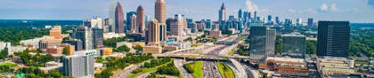 Atlanta skyline with modern skyscrapers and busy highways under a bright blue sky