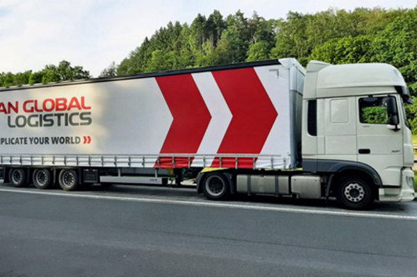 scan-global-logistics-truck-forest-road