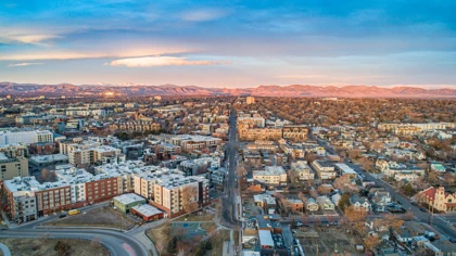 Sunset aerial view of Denver, Colorado, with the Rocky Mountains in the background