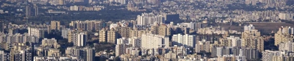 Panoramic skyline of Pune, India, with high-rise buildings and urban districts supporting global logistics networks.