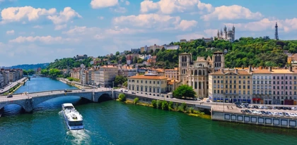 Scenic view of Lyon, France, featuring the Saône River, historic buildings, and Basilica of Notre-Dame de Fourvière