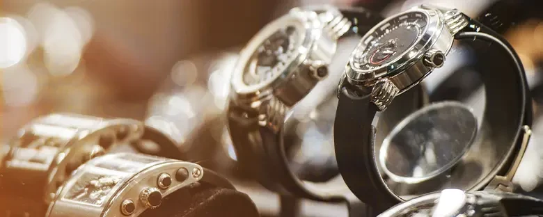 A selection of luxury wristwatches is arranged in a jewelry display case. The high-value items illustrate the need for secure, carefully managed transportation and specialized logistics solutions.
