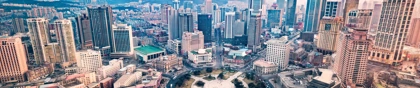 Dalian city skyline featuring modern skyscrapers and a central circular plaza at sunset