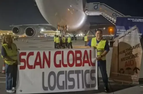 Scan Global Logistics team in front of a cargo aircraft, preparing to ship humanitarian aid during a tight emergency timeline