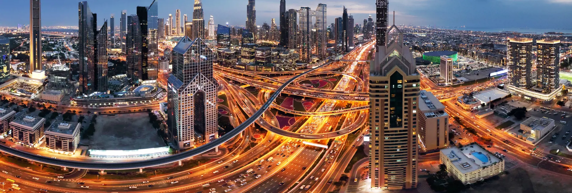Dubai skyline at dusk featuring the Burj Khalifa and modern skyscrapers with text highlighting the UAE's remarkable world records